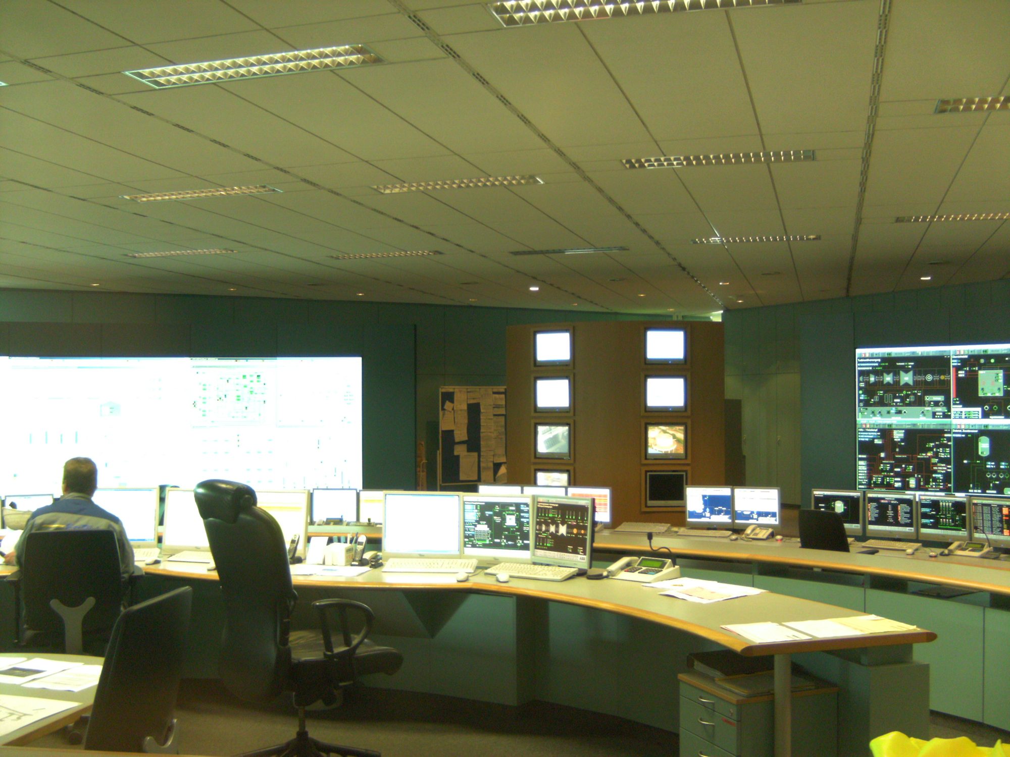 Operators at the desks of a power plant control room